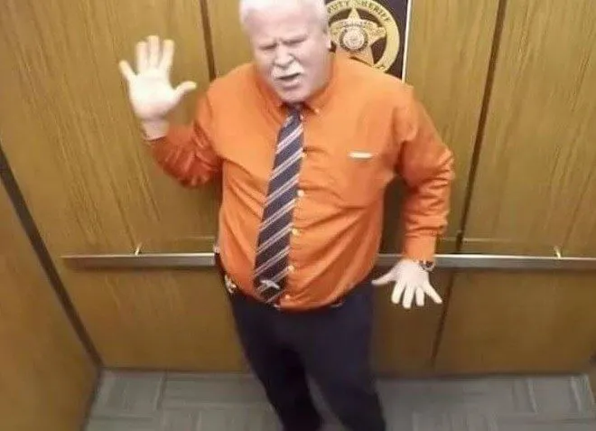 Sheriff Takes a Little Elevator Dance Break
